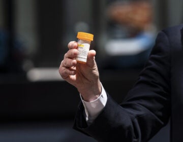 Senate Minority Leader Chuck Schumer, D-N.Y., holds a bottle of hydroxychloroquine while raising concerns about its use. (Lev Radin/Pacific Press/Pacific Press/LightRocket via Getty Images)