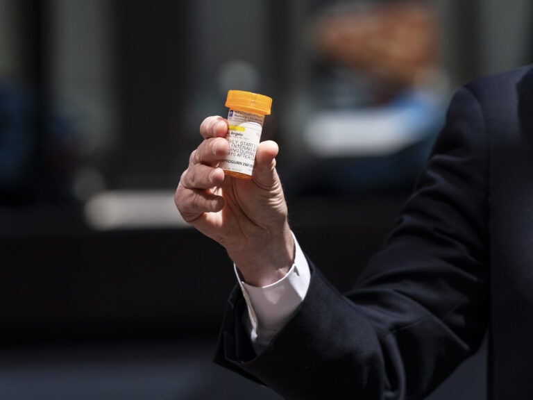 Senate Minority Leader Chuck Schumer, D-N.Y., holds a bottle of hydroxychloroquine while raising concerns about its use. (Lev Radin/Pacific Press/Pacific Press/LightRocket via Getty Images)