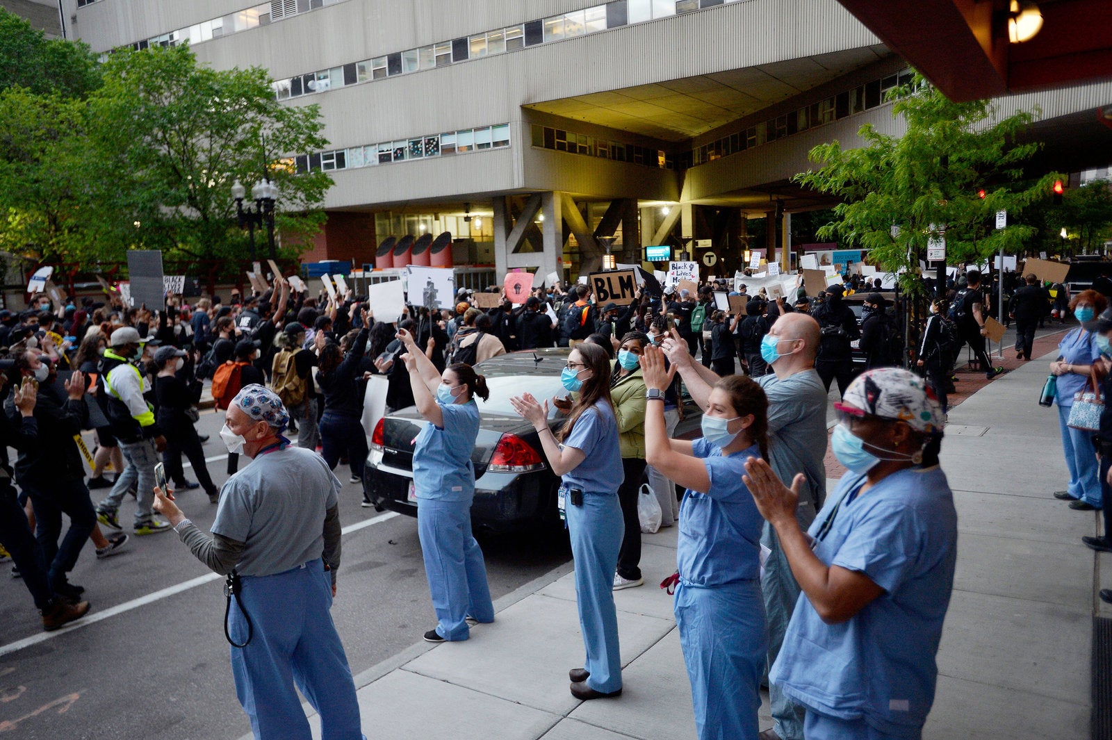 Medical workers applaud protesters outside a hospital during a demonstration over the death of George Floyd in Boston on Sunday.