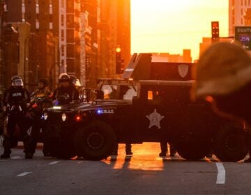 Police officers take guard during a protest over the death of George Floyd last month in Minneapolis.
