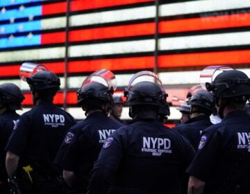 NYPD police officers watch demonstrators in Times Square on June 1, 2020, during a 