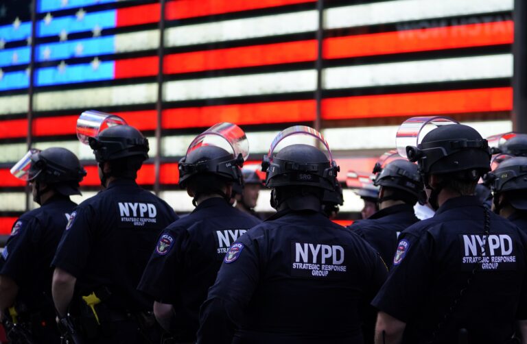 NYPD police officers watch demonstrators in Times Square on June 1, 2020, during a 