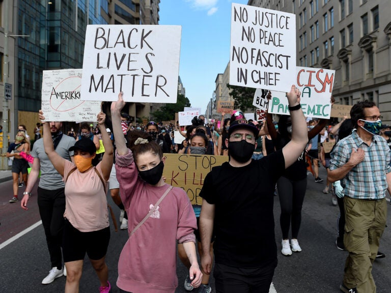 Demonstrators march near the White House on Thursday, protesting the death of George Floyd in Minneapolis police custody. (Olivier Douliery/AFP via Getty Images)