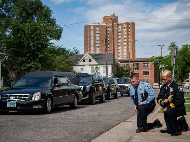 Minneapolis Police Chief Medaria Arradondo (right) kneels as the hearse of George Floyd arrives to North Central University ahead of funeral service on Thursday. Protests in the wake of Floyd's death while in police custody has erupted across the country.
(The Washington Post/The Washington Post via Getty Images)