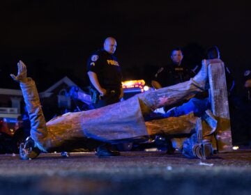 A statue of Confederate States President Jefferson Davis lies on the street after protesters pulled it down in Richmond, Va., on Wednesday. (Parker Michels-Boyce/AFP via Getty Images)