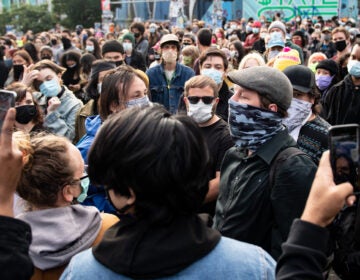 A man carrying a brick is confronted by protesters inside the Capitol Hill Organized Protest in Seattle on June 14.