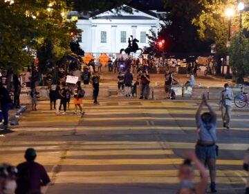 Protesters gather on Friday night at Black Lives Matter Plaza in front of the White House and the statue of former President Andrew Jackson, which is protected by a fence and concrete blocks.