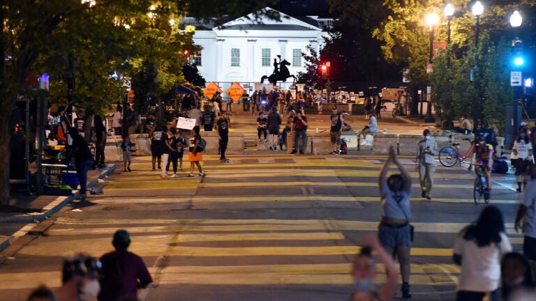 Protesters gather on Friday night at Black Lives Matter Plaza in front of the White House and the statue of former President Andrew Jackson, which is protected by a fence and concrete blocks.