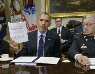 Laurie Robinson and Charles Ramsey listen while President Obama discusses law enforcement recommendations