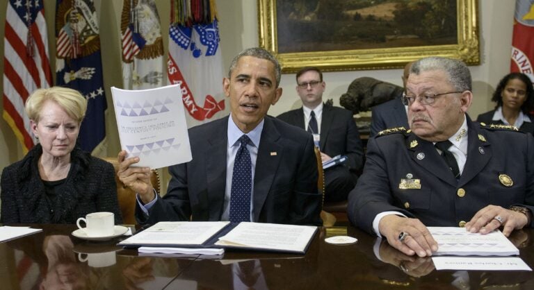 Laurie Robinson and Charles Ramsey listen while President Obama discusses law enforcement recommendations