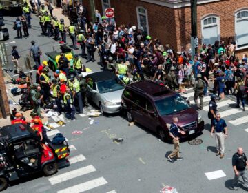 People receive first-aid after a driver ran into a crowd of protesters in Charlottesville