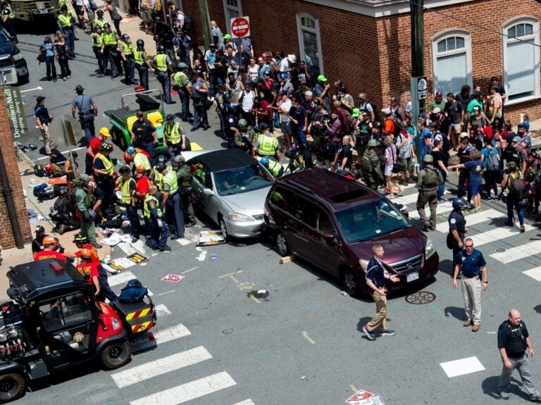 People receive first-aid after a driver ran into a crowd of protesters in Charlottesville