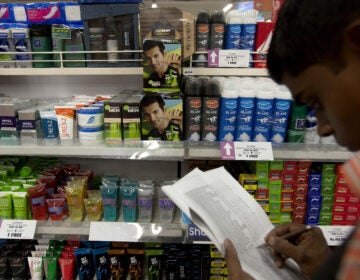 Johnson & Johnson has been one of a number of companies, such as L'Oreal, Procter & Gamble and Unilever, that sell these kinds of products. Here, a store keeper in Mumbai, India, is shown taking stock of beauty and whitening products.