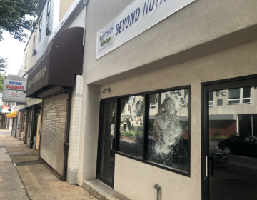 Splintered windows, plywood and shuttered doors mark the 100 block of W. Ninth Street in Wilmington. (Cris Barrish/WHYY)