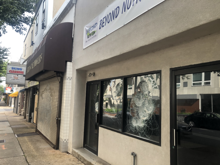 Splintered windows, plywood and shuttered doors mark the 100 block of W. Ninth Street in Wilmington. (Cris Barrish/WHYY)