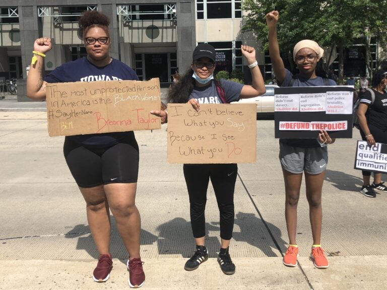 Howard University law students, from left, Chanel Sherrod, Domonique Dille and Temitope Aladetimi brought handmade signs to a protest near the White House last Saturday.