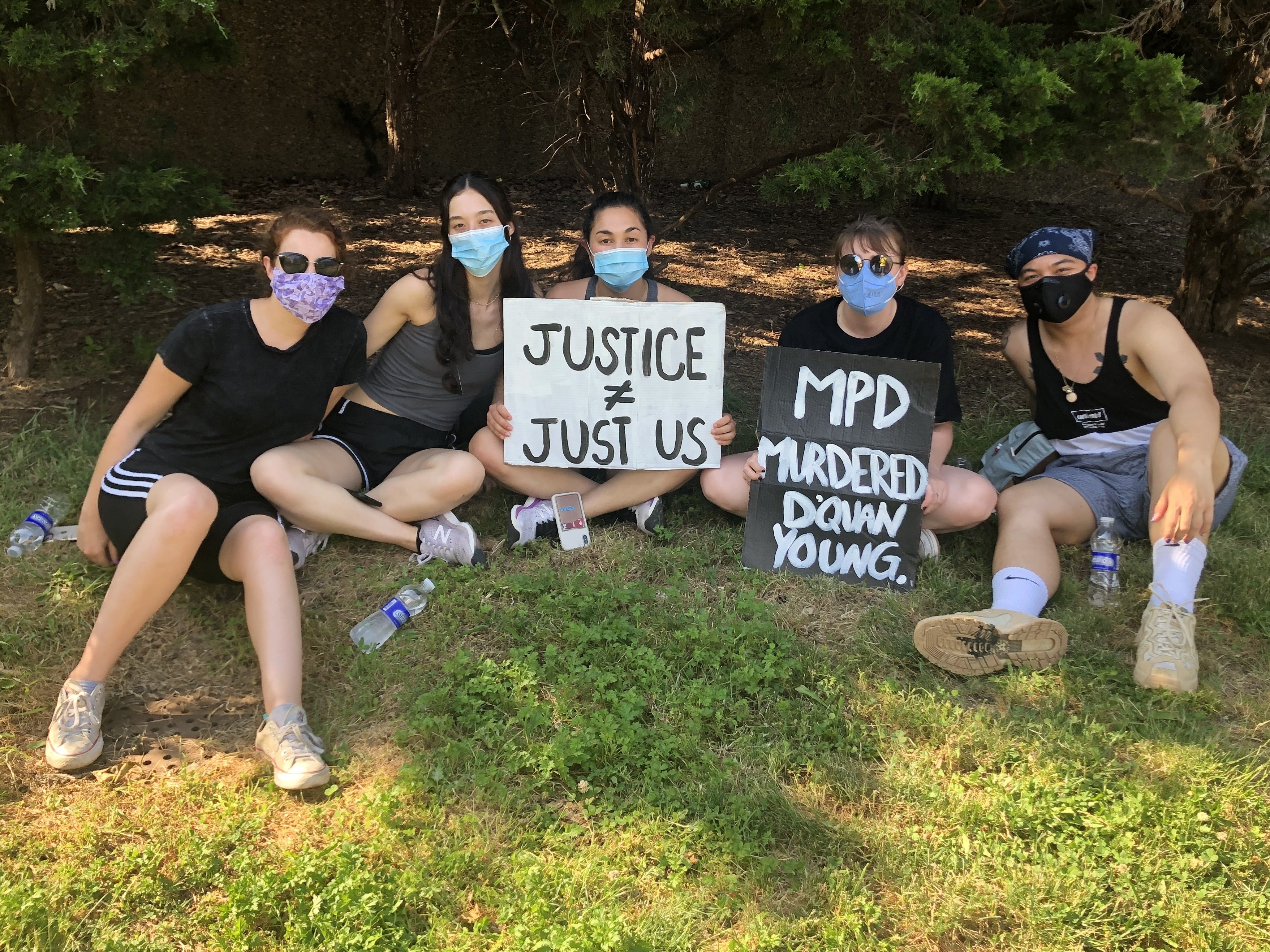 Natalie Spievack (third from left) and Raymond Sison (far right) take a break from protesting with friends at Malcolm X Park in Washington, D.C.