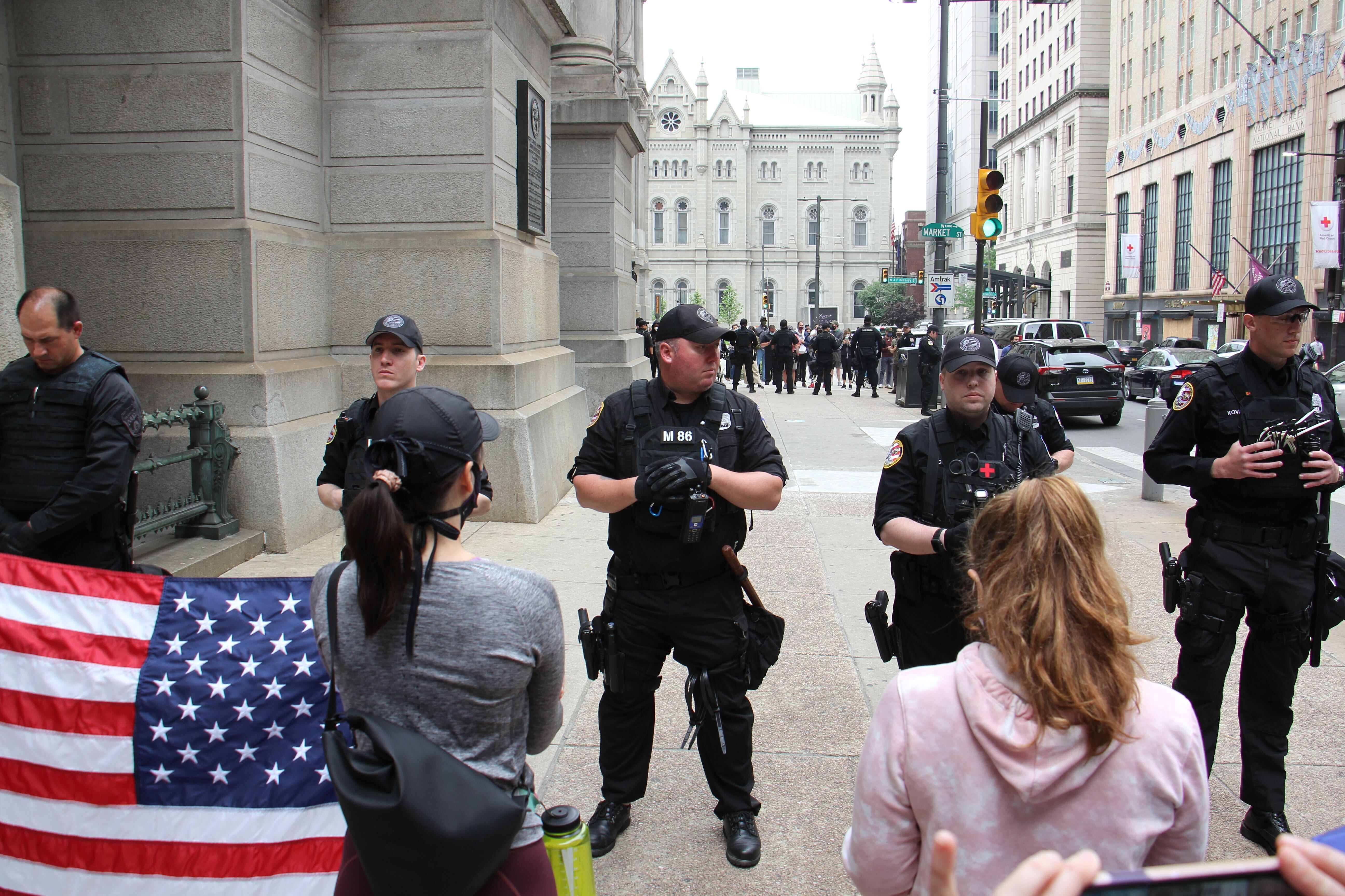 A small crowd gathers outside City Hall