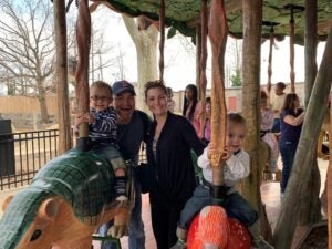 Long before the COVID-19 pandemic, Dr. Lauren Jenkins, her husband, Jay Roux, and their twins, Pierce and Ashton, ride the carousel at the Philadelphia Zoo.