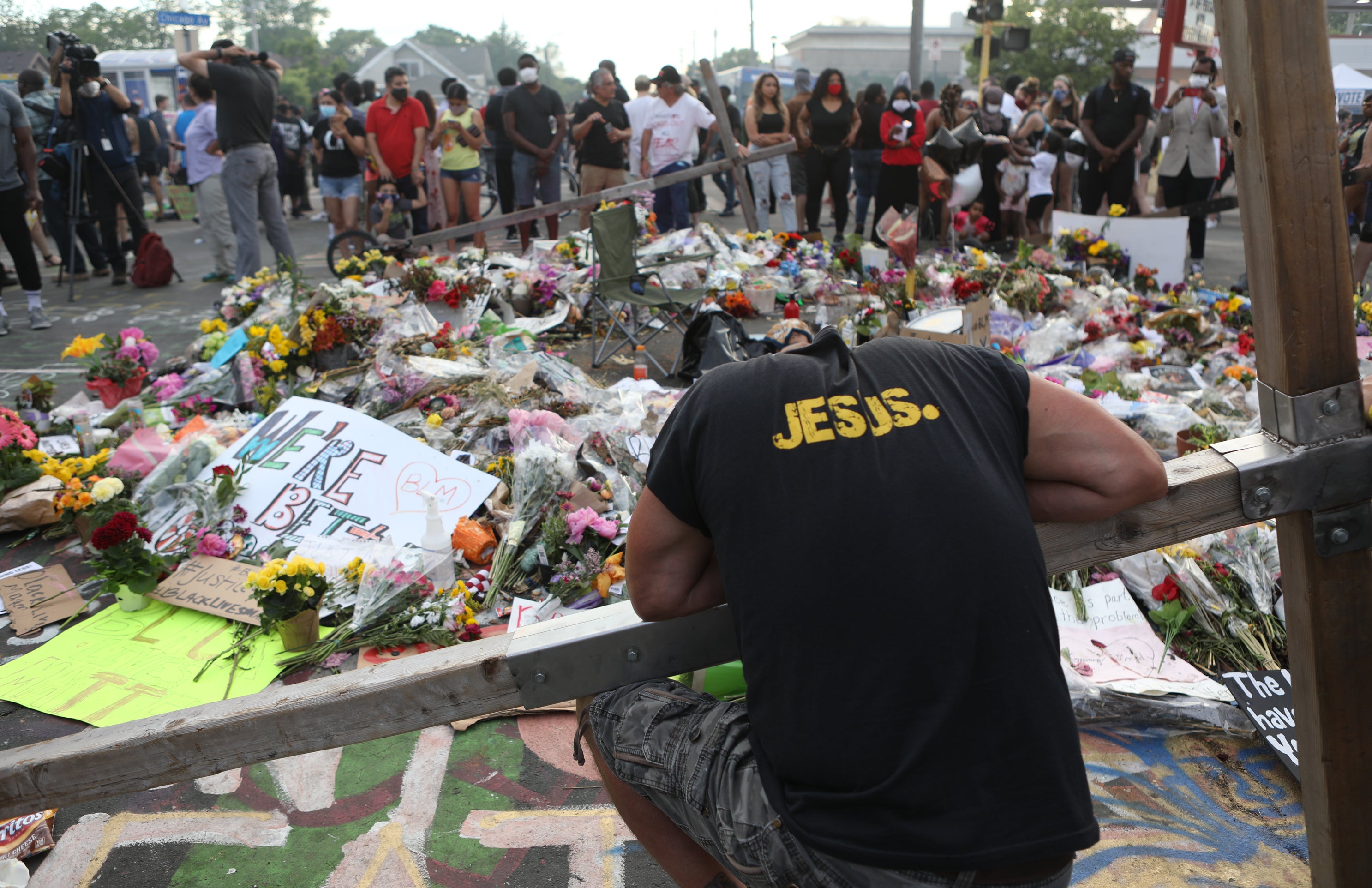 Piles of flower bouquets lay at the site where George Floyd was killed while in police custody.