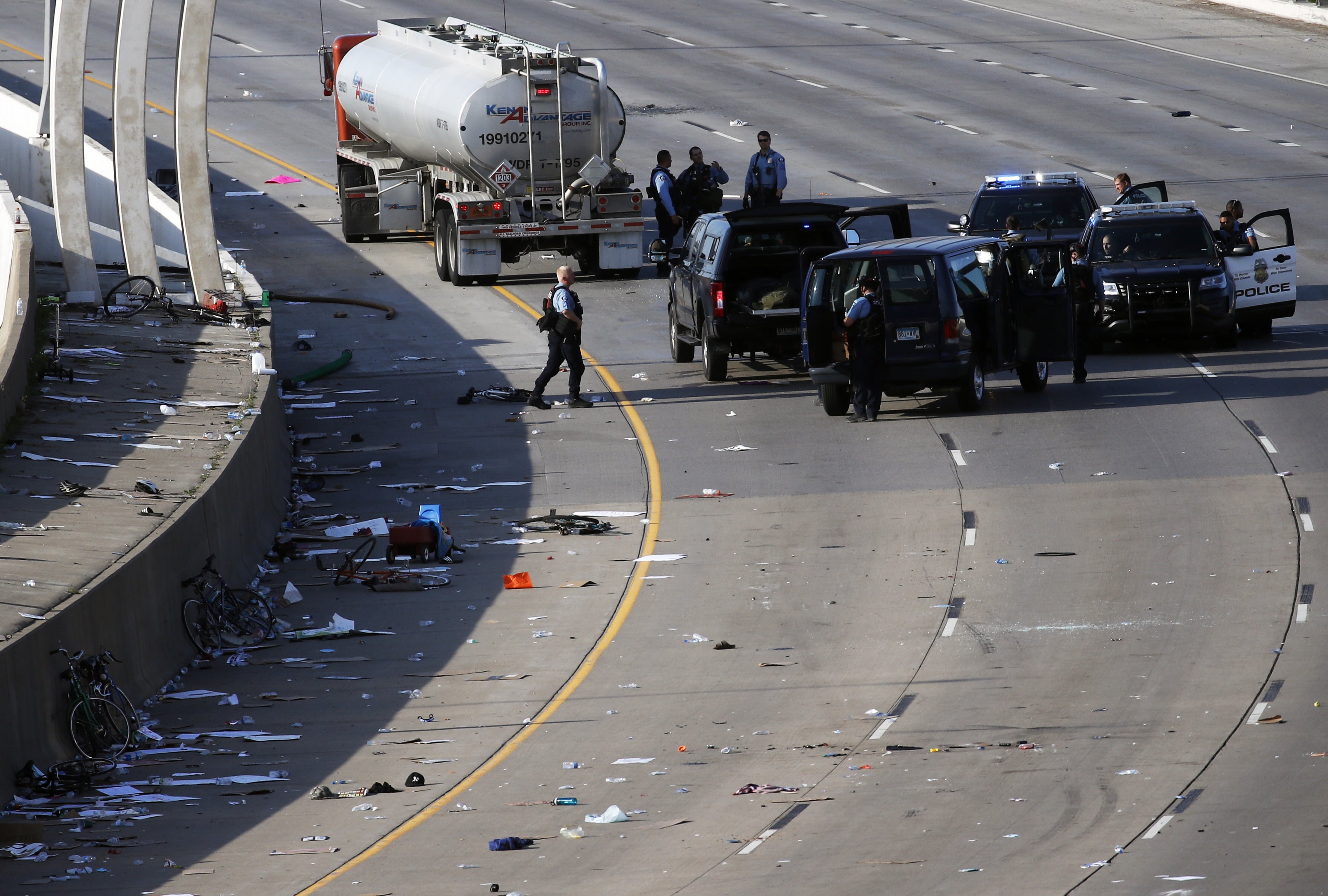 Police clear the area where a tanker truck rushed to a stop among protesters on an interstate highway on Sunday in Minneapoli