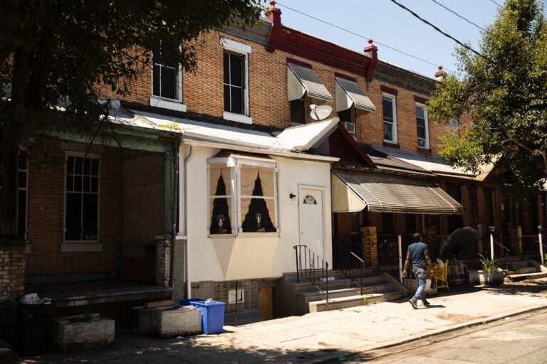 A man walks on the 3700 block of North 15th Street, where a seven-hour police siege happened last year. (Ryan Collerd)