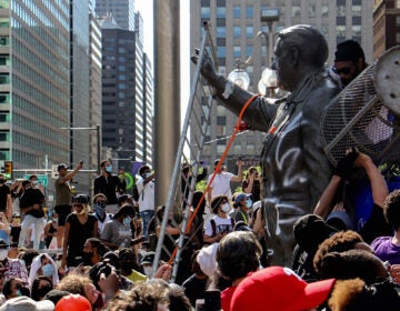 Protesters attacked the Frank Rizzo statue in front of MSB on Saturday. (Emma Lee / WHYY)