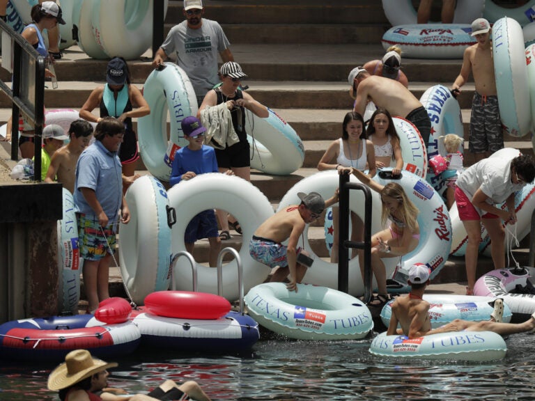 Tubers prepare to float the Comal River in New Braunfels, Texas, on Thursday, despite the recent spike in COVID-19 cases. Texas Gov. Greg Abbott said Wednesday that the state is facing a 