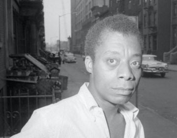 Author James Baldwin is shown on a Harlem street in New York City, June 3, 1963.  (AP Photo/stf)