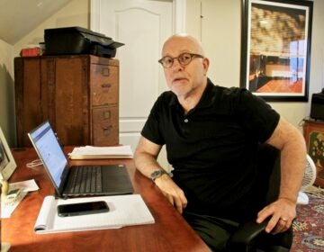 Contact tracer Neil Lader reaches out to COVID-19 patients from his home in Haverford. (Emma Lee/WHYY)