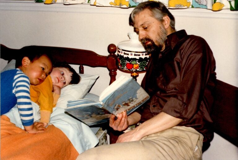 Hugh Frick reads to his children, Tim and Tegan, in a photo taken circa 1980. (Courtesy of Tim Frick)