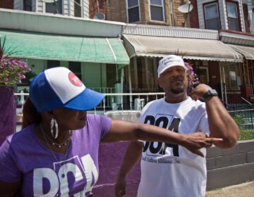 Saj Blackwell points to Thomas Blackwell’s scar, where he was nicked with a rubber bullet the night of protests and looting on 52nd Street in Philadelphia. (Kimberly Paynter/WHYY)