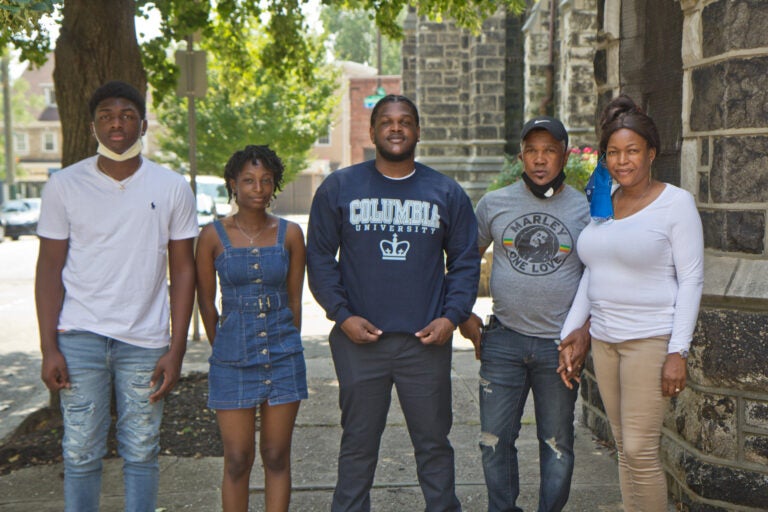 CJ Thompson (center) with his parents Oneita and Clive Thompson-Lewis (right), and his siblings, Christine, 17, and Timothy, 14. (Kimberly Paynter/WHYY)