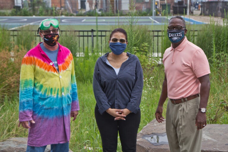 Patterson Elementary Principal Kenneth Jessup (right), with second grade teacher Marjorie Thomas (center), and K-4 science teacher John Steczak (left), at the area next to the school where outdoor class is planned to take place. (Kimberly Paynter/WHYY)