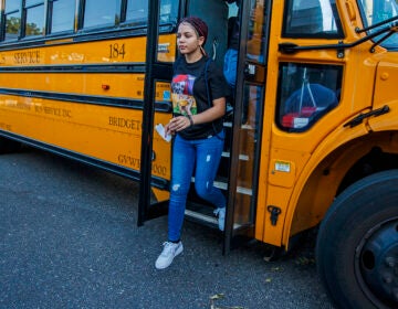 A student gets off the bus for the 1st day of school at Oakcrest High School on Tuesday. Sept. 3, 2019. (Craig Matthews/The Press of Atlantic City via AP)