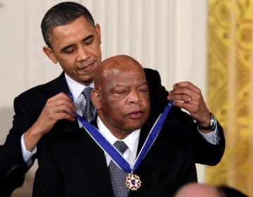 FILE - In this Feb. 15, 2011, file photo, President Barack Obama presents a 2010 Presidential Medal of Freedom to U.S. Rep. John Lewis, D-Ga., during a ceremony in the East Room of the White House in Washington. Lewis, who carried the struggle against racial discrimination from Southern battlegrounds of the 1960s to the halls of Congress, died Friday, July 17, 2020. (AP Photo/Carolyn Kaster, File)