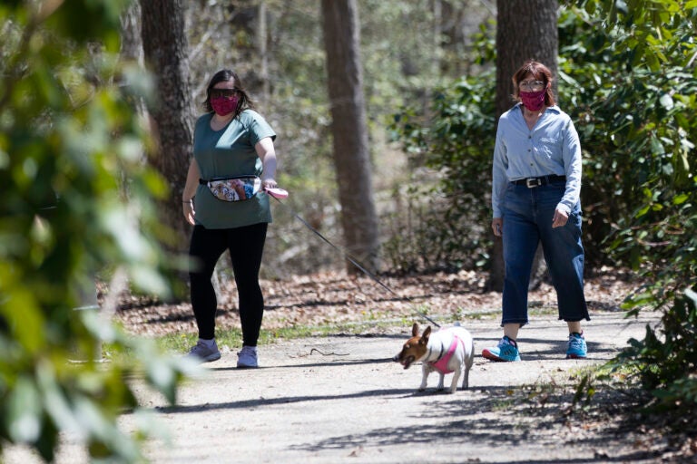 People wearing a protective face coverings hike at Shark River Park in Wall Township, N.J., Saturday, May 2, 2020. (AP Photo/Matt Rourke)