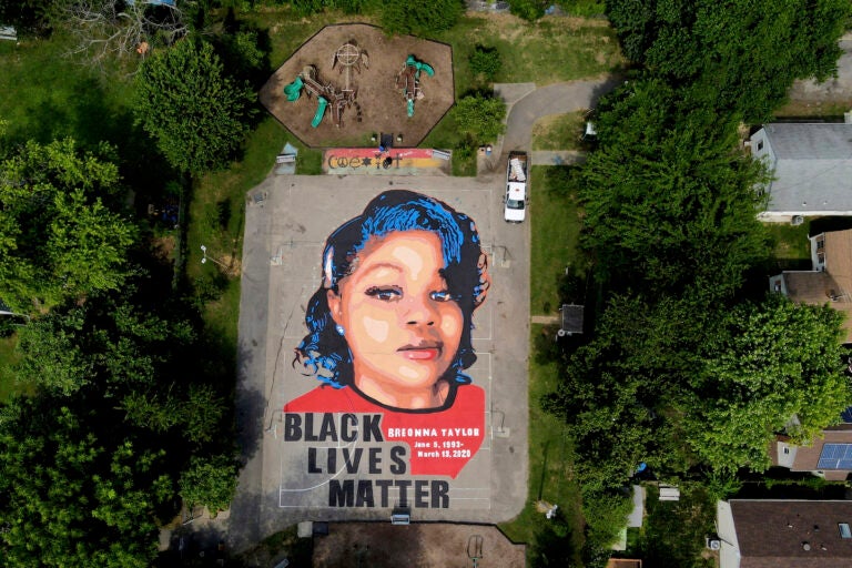 A ground mural depicting a portrait of Breonna Taylor is seen at Chambers Park, Monday, July 6, 2020, in Annapolis, Md. The mural honors Taylor, a 26-year old Black woman who was fatally shot by police in her Louisville, Kentucky, apartment. The artwork was a team effort by the Banneker-Douglass Museum, the Maryland Commission on African American History and Culture, and Future History Now, a youth organization that focuses on mural projects. (AP Photo/Julio Cortez)