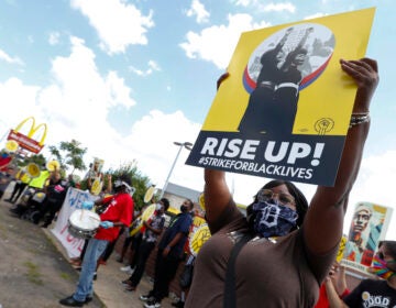 Protesters rally outside a McDonald's in Detroit, Monday, July 20, 2020. The national workers strike saw people walk off the job Monday in U.S. cities to protest systemic racism and economic inequality. (AP Photo/Paul Sancya)