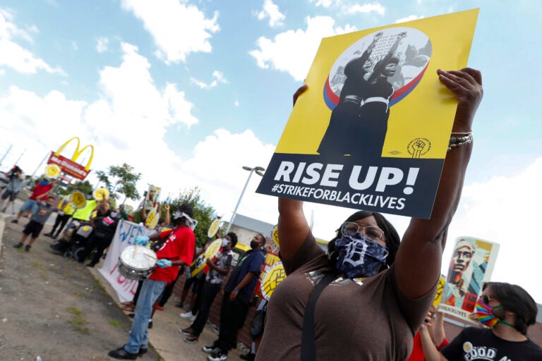 Protesters rally outside a McDonald's in Detroit, Monday, July 20, 2020. The national workers strike saw people walk off the job Monday in U.S. cities to protest systemic racism and economic inequality. (AP Photo/Paul Sancya)