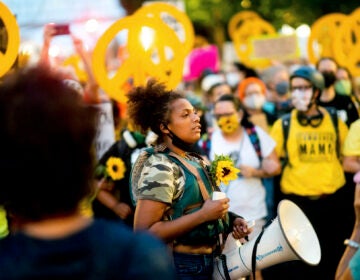 In this July 22, 2020 file photo Black Lives Matter organizer Teal Lindseth, 21, leads protesters in Portland, Ore. (AP Photo/Noah Berger)