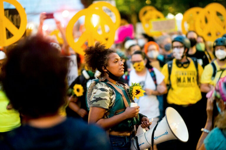 In this July 22, 2020 file photo Black Lives Matter organizer Teal Lindseth, 21, leads protesters in Portland, Ore. (AP Photo/Noah Berger)