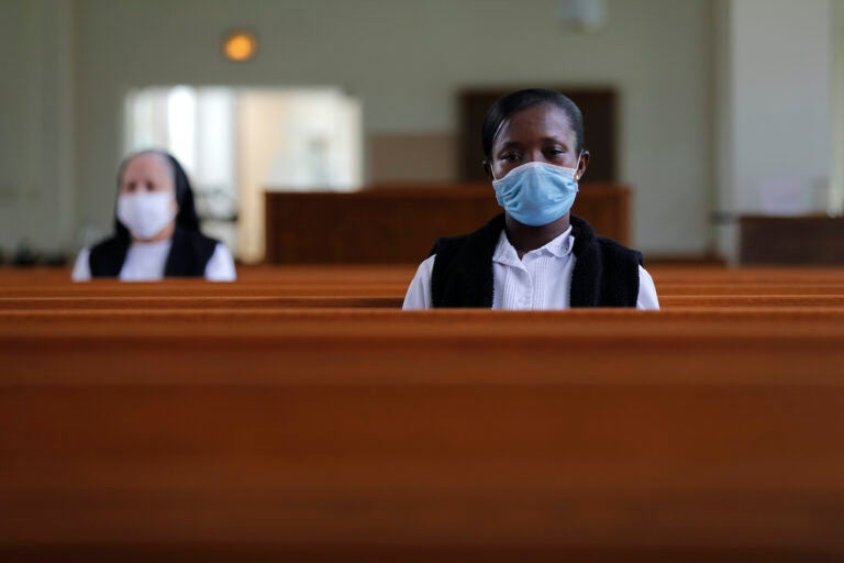 Faustina Bema, a candidate for Novice of the Sisters of the Holy Family, prays inside a chapel during a retreat at their Mother House in New Orleans, Thursday, July 23, 2020. (AP Photo/Gerald Herbert)