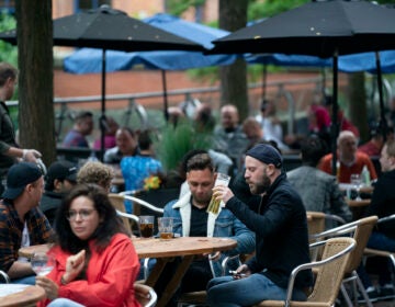 Members of the public are seen at a bar on Canal Street