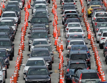 Lines of cars wait at a drive-through coronavirus testing site