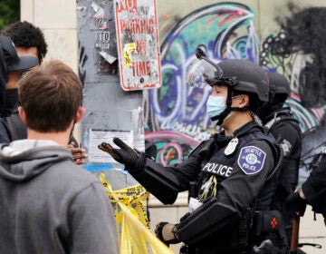 A police officer engages with a protester