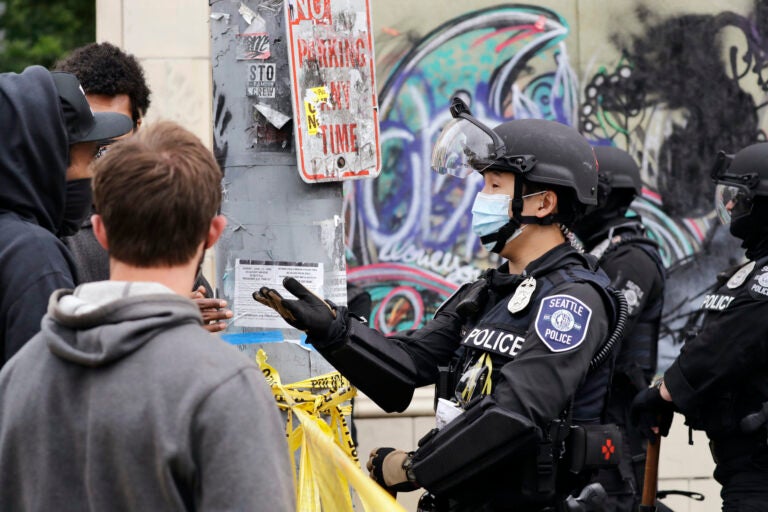 A police officer engages with a protester