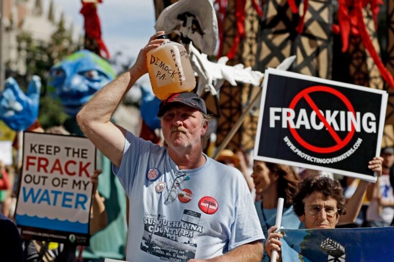 In this Sept. 20, 2012, file photo, Ray Kemble, of Dimock, Pa., holds a jug of his well water on his head while marching with demonstrators against hydraulic fracturing outside a Marcellus Shale industry conference in Philadelphia. (AP Photo/Matt Rourke, File)