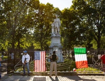 A group of armed people guard a statue of Christopher Columbus located in Marconi Park on South Broad St. These men said they believed that Black Lives Matter/ANTIFA protestors were on their way to destroy the statue. (Courtesy of Ryan Collerd)