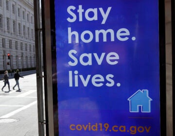 In San Francisco, a poster seen in March urges the public to socially distance in an effort to contain the spread of the coronavirus.